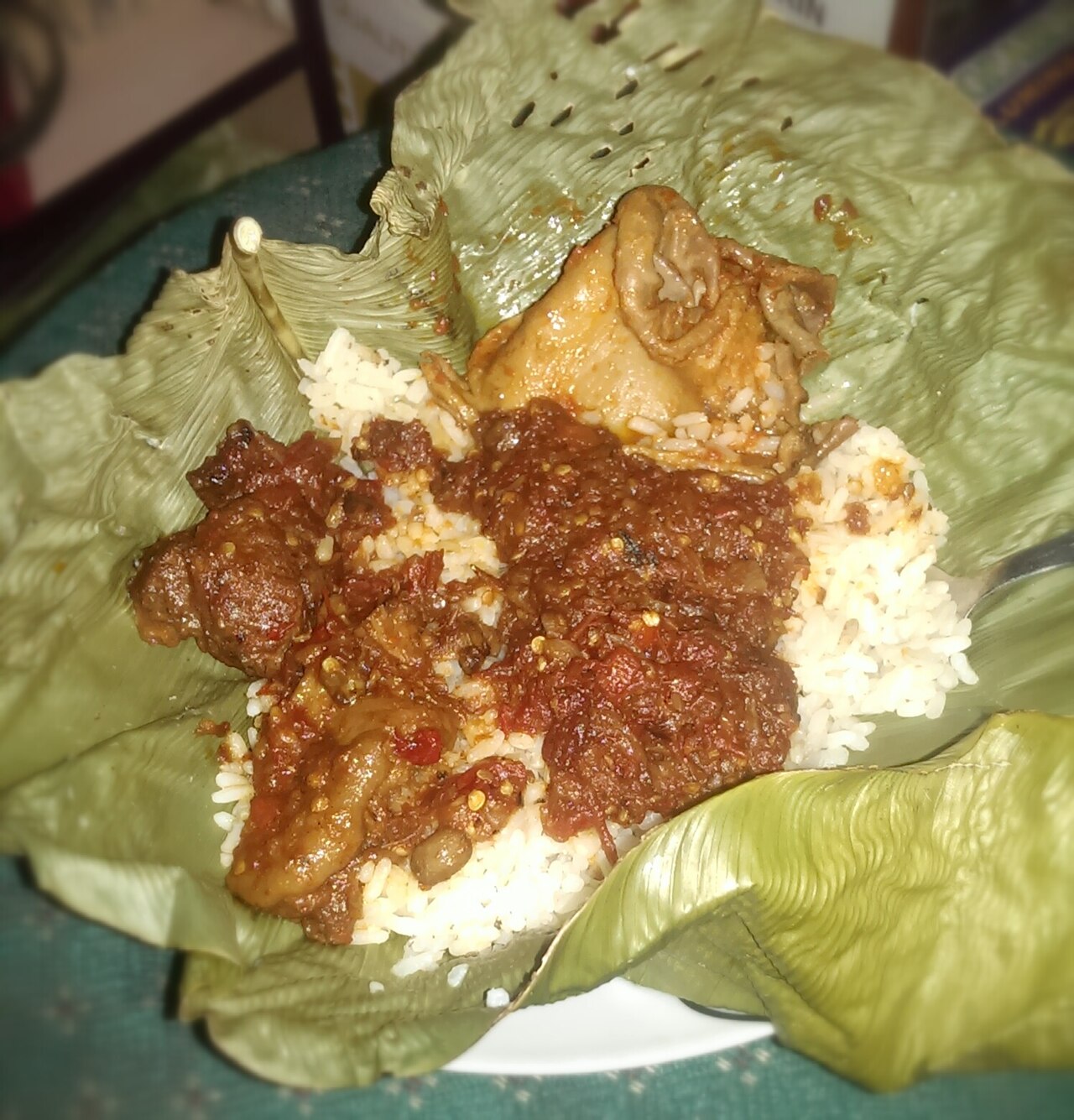 Ofada rice — a less processed Nigerian rice variety; a small portion alongside a vegetable-rich stew is a solid choice