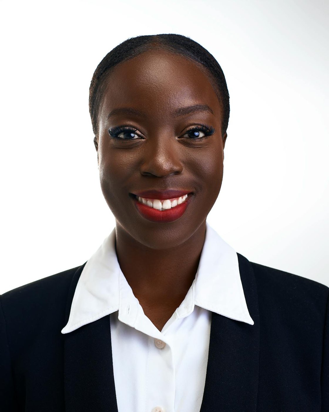 A smiling woman in a dark blazer